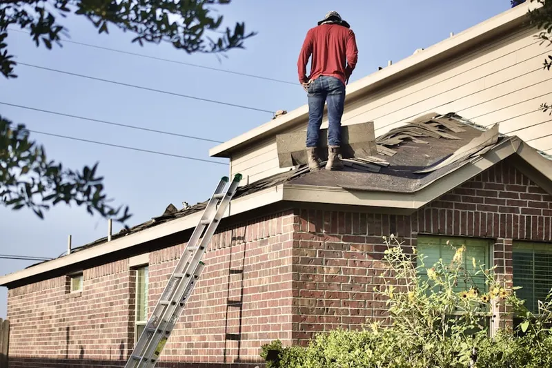 Professional roofer working on a residential roof in Brickell Village